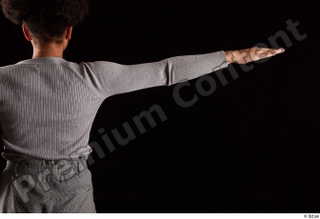 Zahara  1 arm back view dressed flexing grey sweatshirt…